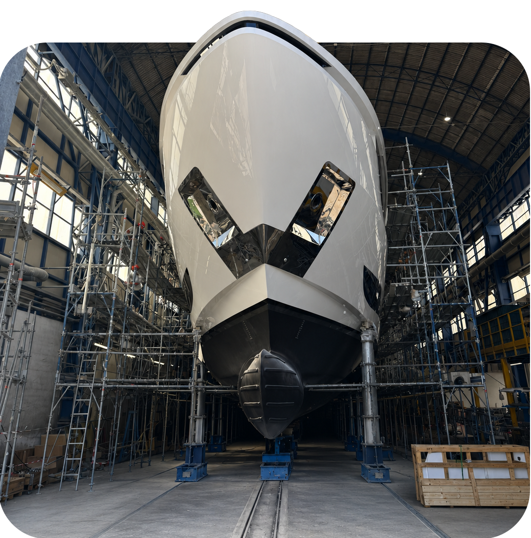 Front view of a large ship in a dry dock with scaffolding around it